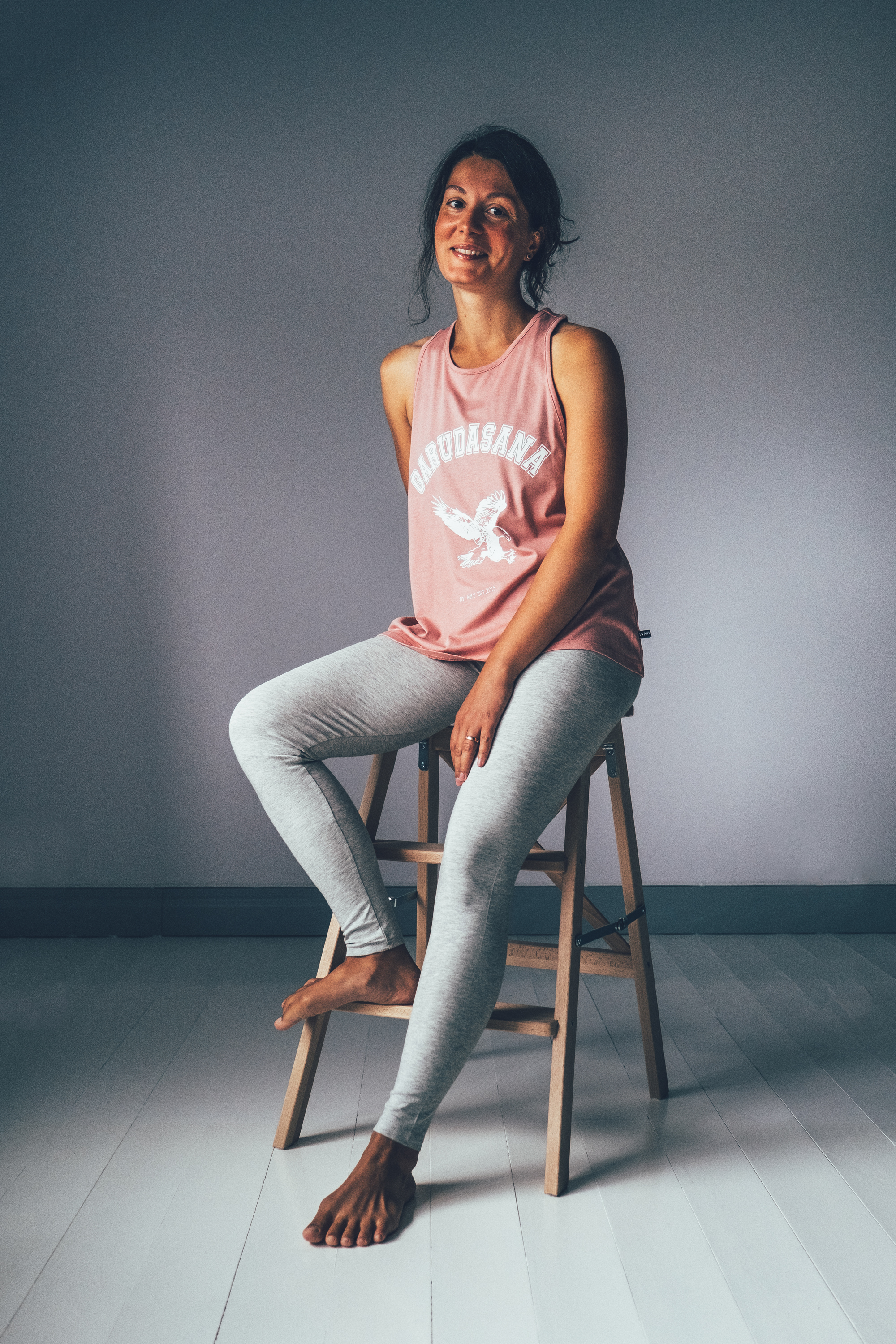 Pink sports tank top with Guradasana printed at the front in white.