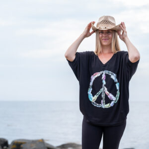 Girl wearing a top with a peace print.