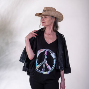Lady in a black Peace top and cowboy hat.